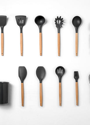 Set of black kitchen utensils with wooden handles on a white background