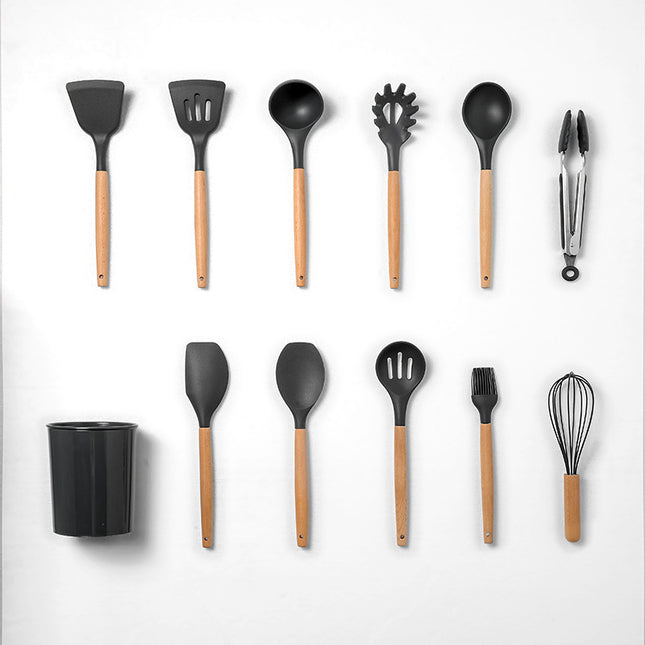 Set of black kitchen utensils with wooden handles on a white background