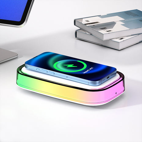 Wireless charging pad with smartphone on a white surface