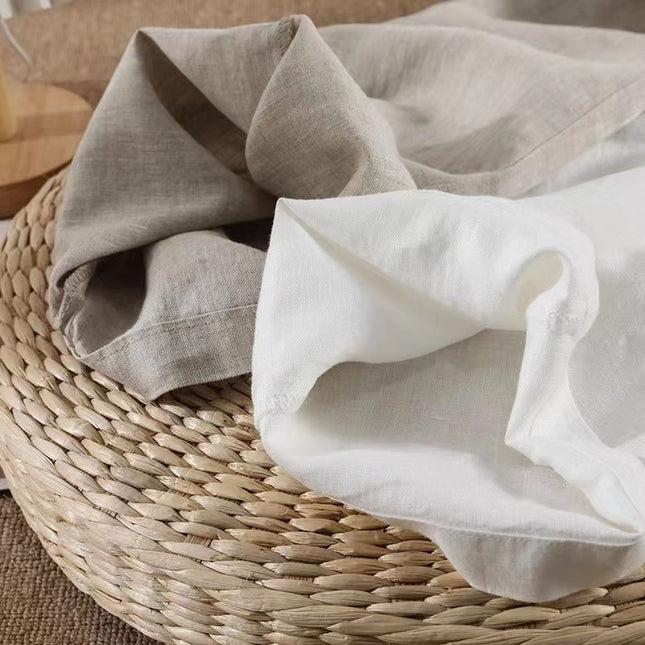 Folded beige and white fabric on a woven basket