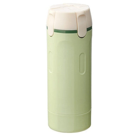 Green four-in-one dispensing bottle with white cap on a white background