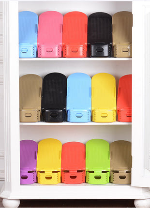 Colorful plastic bins on a white shelf against a white wall.