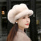 Woman wearing a beige fur hat with a blurred background