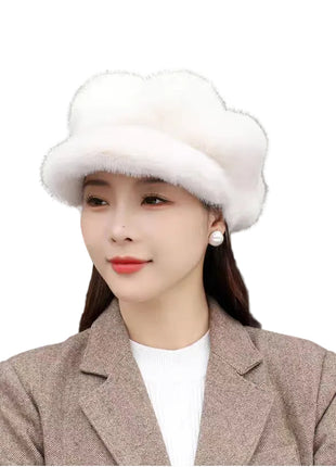 Woman wearing a white fur hat indoors with blurred background