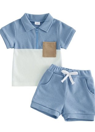 Children's blue and white checkered polo shirt with a brown pocket and matching shorts on a white background