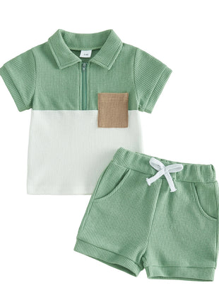 Children's green checkered polo shirt and shorts set on a white background