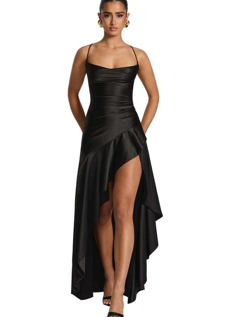 Woman wearing a black satin dress with a high-low hem on a white background