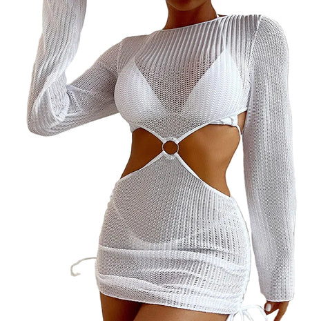 White mesh dress with cut-out design worn by a person, sitting on a couch.