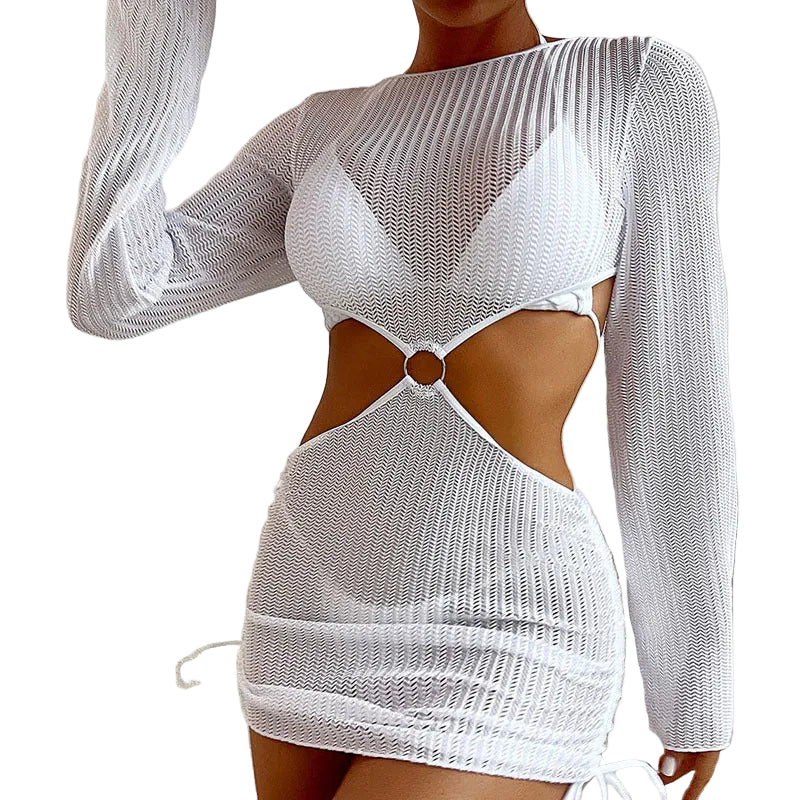 White mesh dress with cut-out design worn by a person, sitting on a couch.