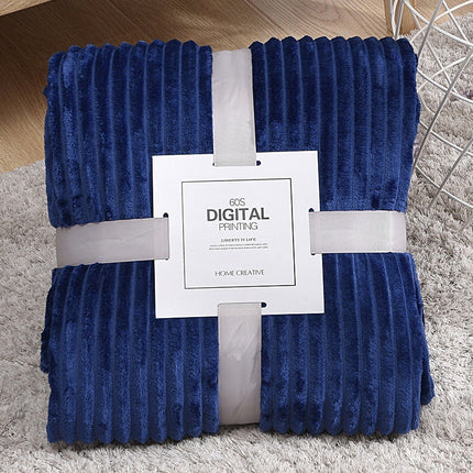 Blue textured blanket with a white label on a gray surface