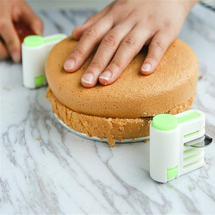 Person using a cake leveler to smooth layers of cake on a marble surface