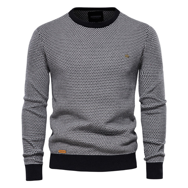 Gray patterned sweater with black accents on a white background