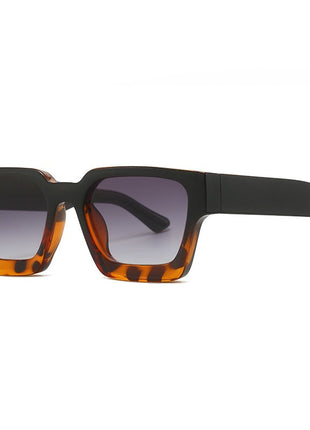 Sunglasses with tortoiseshell frame and dark lenses on a white background
