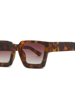 Sunglasses with tortoiseshell frame and gradient lenses on a white background