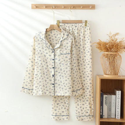 Floral pajama set hanging on a rack with a wooden shelf and books in the background.