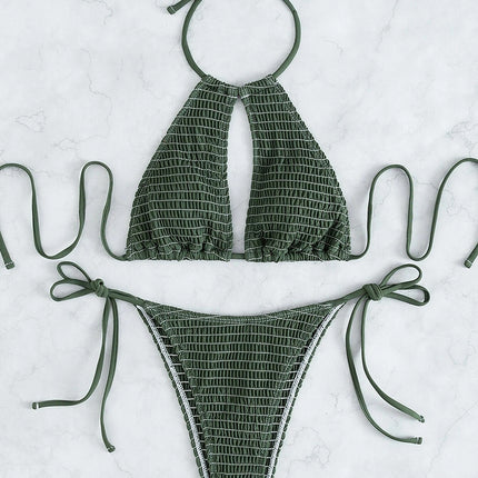 Green bikini set with halter top and tied sides on a light gray background