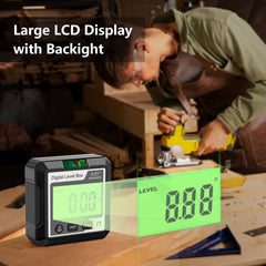 Digital level box with large LCD display and backlight on a workbench, used by a person working on wood.
