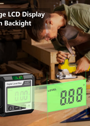 Digital level box with large LCD display and backlight on a workbench, used by a person working on wood.
