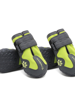 Pair of green and gray pet boots with paw design on a white background