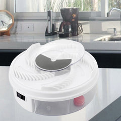 White electronic device on a kitchen counter with a coffee maker and clock in the background