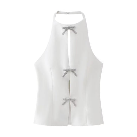 Elegant white halter top with a decorative bow detail and an open-back silhouette for sophisticated styling.