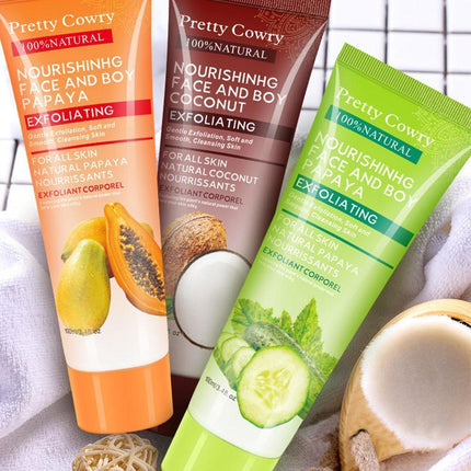 Three tubes of 'Pretty Cowry' facial and body exfoliating products with papaya, coconut, and cucumber imagery.