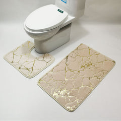 Beige marble-patterned bath mats in front of a white toilet on a light gray background