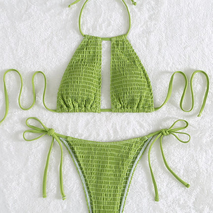 Green bikini set on a textured white background