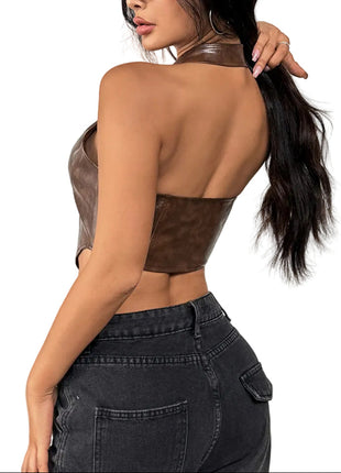 Woman wearing a brown leather top and black jeans on a white background