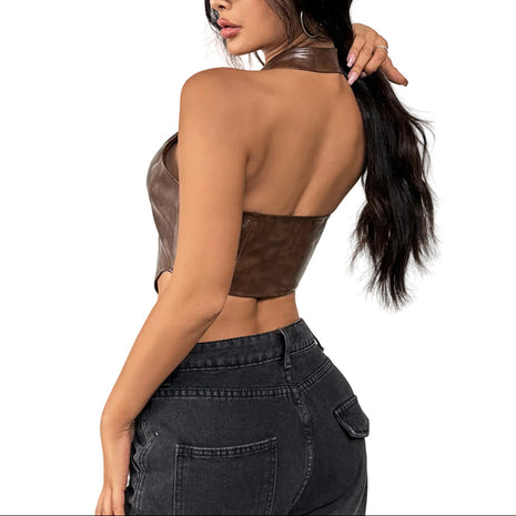 Woman wearing a brown leather top and black jeans on a white background