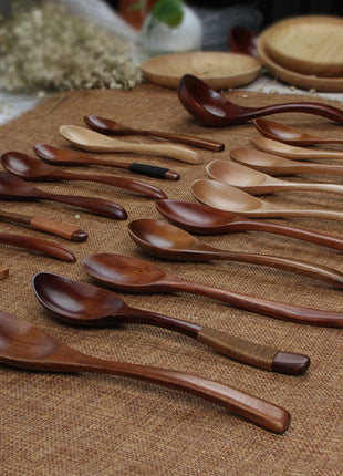 Set of wooden spoons on a textured surface