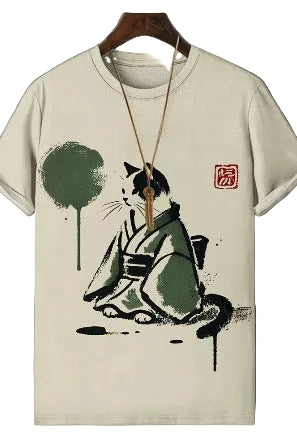 Beige t-shirt with a black and white cat illustration and a tree on a gray background
