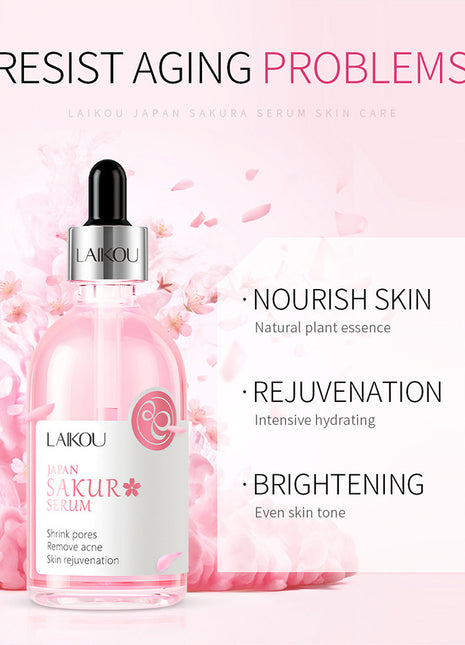 Laikou Sakura Serum bottle with cherry blossoms on a pink background