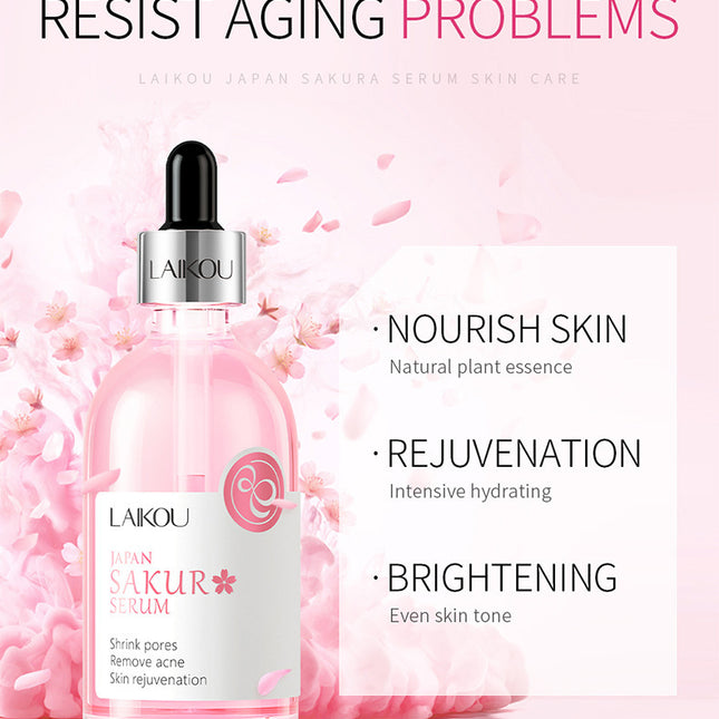 Laikou Sakura Serum bottle with cherry blossoms on a pink background