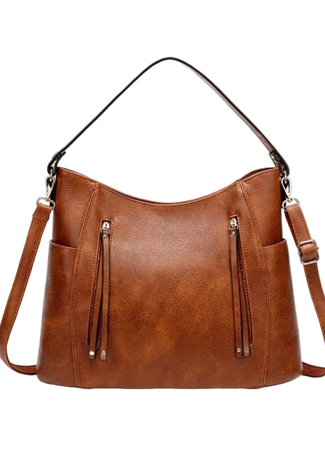 Brown leather handbag with shoulder straps on a white background