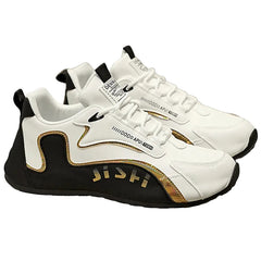 White and black sneakers with gold accents on a chair