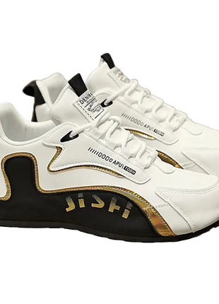 White and black sneakers with gold accents on a chair