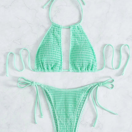 Mint green bikini set on a light gray background