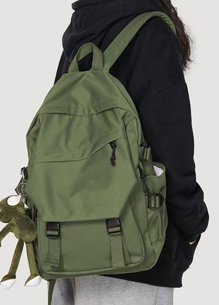Person wearing a green backpack on a plain background