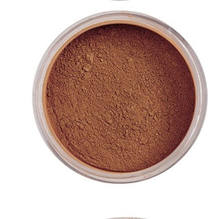 Brown powder in a small open container on a white background