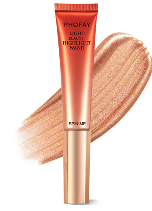 A PHOFAY Highlighter Wand in a golden bronze shade, with a swatch of the product showing its luminous and creamy texture.