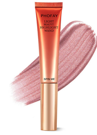 A PHOFAY Highlighter Wand in a golden bronze shade, with a swatch of the product showing its luminous and creamy texture.