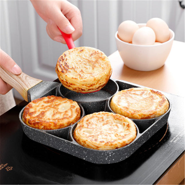 Person using a non-stick muffin pan with freshly baked muffins on a kitchen counter.