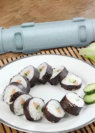 Sushi rolls on a plate with a sushi rolling tool and lettuce in the background.