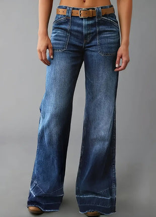 Blue jeans worn by a person on a gray background blndl