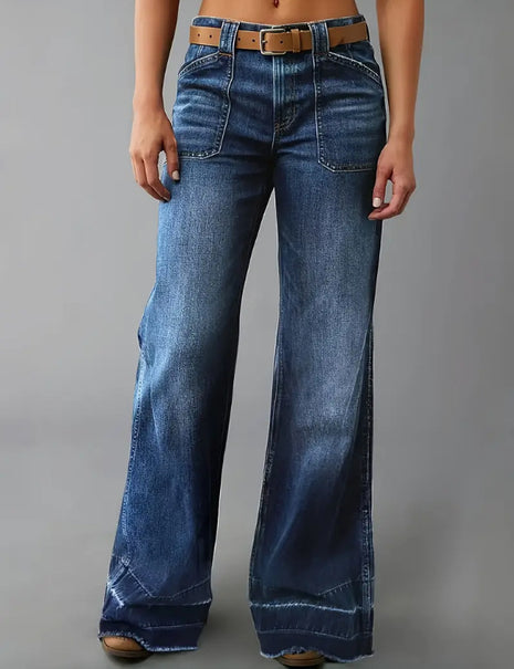 Blue jeans worn by a person on a gray background blndl