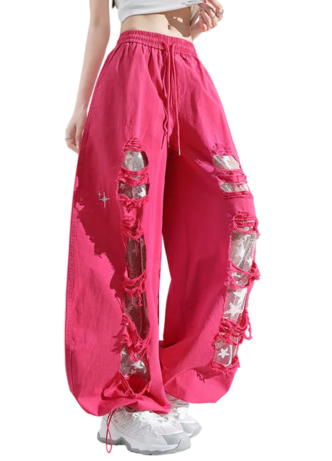 Pink pants with rhinestone embellishments on a gray background