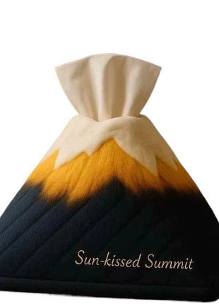 Decorative pillow with mountain design and 'Sun-kissed Summit' text on a white background