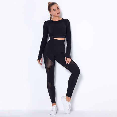Woman wearing a black athletic outfit on a white background
