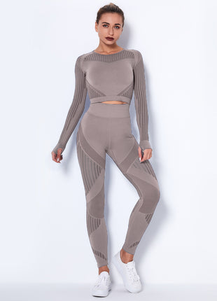 Woman wearing a gray knit outfit on a white background
